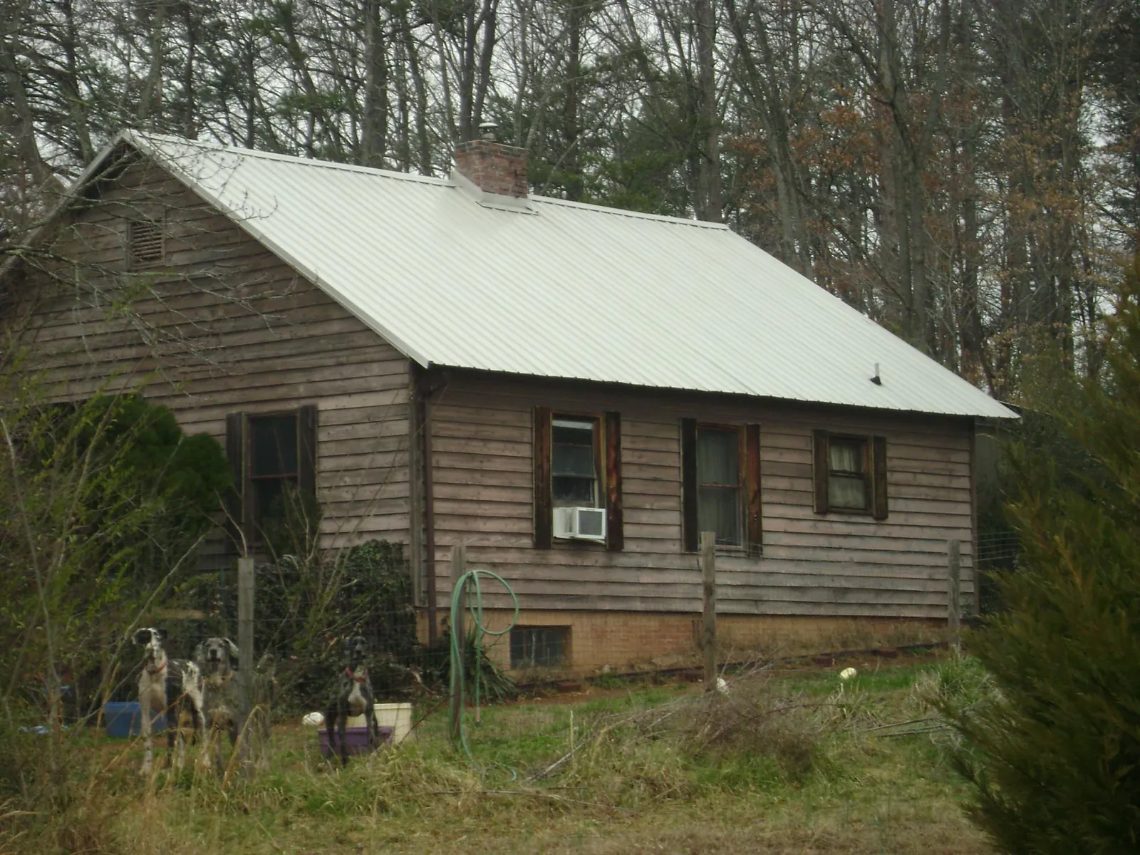 White metal roof on an old wood sided farmhouse, from a Metal Roof Installation job in Thurmond